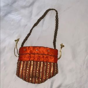 Orange potli (pouch) purse with gold embroidery